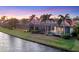 Waterfront backyard featuring a screened-in pool and lush green lawn at 15606 Leven Links Pl, Lakewood Ranch, FL 34202