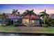 Backyard view of a house with a screened-in pool area and lush green lawn at 15606 Leven Links Pl, Lakewood Ranch, FL 34202