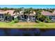 Waterfront backyard featuring a screened-in pool and tropical landscaping, creating a private oasis at 15606 Leven Links Pl, Lakewood Ranch, FL 34202