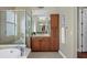 This bathroom boasts wood cabinets, double sinks, and a walk-in shower at 15606 Leven Links Pl, Lakewood Ranch, FL 34202