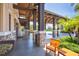Covered walkway entrance features stone pillars and tiled floors providing a welcoming shaded entrance to the clubhouse at 15606 Leven Links Pl, Lakewood Ranch, FL 34202