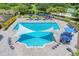 Upscale community pool with shaded areas, a sundeck, and lush landscaping offering a luxurious leisure experience at 15606 Leven Links Pl, Lakewood Ranch, FL 34202