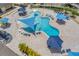 Aerial view of a resort-style pool with seating, umbrellas, and a splash pad for Gathering fun and relaxation at 15606 Leven Links Pl, Lakewood Ranch, FL 34202
