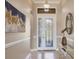 A welcoming foyer featuring a decorative front door with sidelights and transom window at 15606 Leven Links Pl, Lakewood Ranch, FL 34202