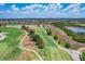Scenic aerial view of a meticulously maintained golf course with lush green fairways and pristine landscaping at 15606 Leven Links Pl, Lakewood Ranch, FL 34202
