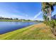 Picturesque golf course view with a pond, lush green grass, and blue sky at 15606 Leven Links Pl, Lakewood Ranch, FL 34202