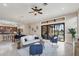 Open-concept living room with a dining area, neutral decor, and sliding glass doors to the outdoor living space at 15606 Leven Links Pl, Lakewood Ranch, FL 34202