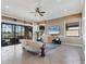 Living room featuring a light sofa, stylish chairs, and a large screen TV at 15606 Leven Links Pl, Lakewood Ranch, FL 34202