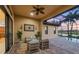 Relaxing covered patio with outdoor seating, overlooking a pool and lush scenery at 15606 Leven Links Pl, Lakewood Ranch, FL 34202