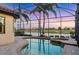 Sparkling pool and spa surrounded by a screened enclosure and mature landscaping at 15606 Leven Links Pl, Lakewood Ranch, FL 34202