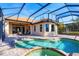 This is a beautifully screened pool with a tanning ledge and brick pavers for outdoor living at 15606 Leven Links Pl, Lakewood Ranch, FL 34202