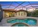 Gorgeous pool area with a spillover spa and a screened enclosure at 15606 Leven Links Pl, Lakewood Ranch, FL 34202