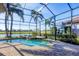 Screened pool and spa combo with brick pavers and views of a golf course and lake at 15606 Leven Links Pl, Lakewood Ranch, FL 34202