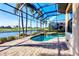 Screened lanai with a paver deck, heated pool, and lovely lake and golf views at 15606 Leven Links Pl, Lakewood Ranch, FL 34202