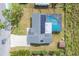 Aerial view of house with solar panels, pool and screened enclosure, and spacious driveway at 1622 17Th E St, Bradenton, FL 34208
