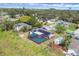 Aerial view of a fenced backyard featuring a screened pool and solar panels on house at 1622 17Th E St, Bradenton, FL 34208