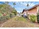 Spacious backyard with well-maintained lawn, fencing, and mature trees at 1622 17Th E St, Bradenton, FL 34208