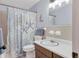 Bathroom featuring a sink, mirror, toilet, and a shower with a nautical themed curtain at 1622 17Th E St, Bradenton, FL 34208