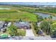Home featuring solar panels, large backyard, long driveway, and views of a pond at 1622 17Th E St, Bradenton, FL 34208