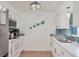Bright kitchen featuring modern appliances, white cabinets, and backsplash at 1622 17Th E St, Bradenton, FL 34208