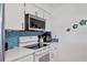 Kitchen with white cabinets, stainless steel appliances, and backsplash at 1622 17Th E St, Bradenton, FL 34208