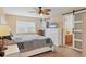 Comfortable main bedroom with a ceiling fan, sliding barn door to the bathroom, and a large window at 1622 17Th E St, Bradenton, FL 34208