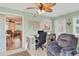 Cozy home office featuring a comfortable recliner, desk with drawers, a ceiling fan, and natural light at 1622 17Th E St, Bradenton, FL 34208