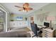 Functional office space with built-in storage, a large screen TV, ceiling fan, and comfortable office chair at 1622 17Th E St, Bradenton, FL 34208