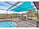 Relaxing screened-in pool area with shade covering, dining set, and clear views at 1622 17Th E St, Bradenton, FL 34208