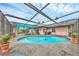 Exterior view of the pool and its surrounding area, with covered seating and lush landscaping at 1622 17Th E St, Bradenton, FL 34208