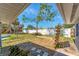 Fenced backyard space with plants, mature trees, and potential at 2121 Florinda St, Sarasota, FL 34231