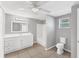 Bright bathroom featuring white vanity, shower, tiled floor, and modern fixtures at 2121 Florinda St, Sarasota, FL 34231
