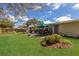 Spacious backyard featuring lush lawn, patio furniture, and shade at 3053 Concord St, Sarasota, FL 34231