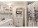 Bright bathroom featuring white cabinets, a stylish shower curtain, and ample storage in shelving at 3053 Concord St, Sarasota, FL 34231