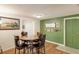 Cozy dining room with a round table, four chairs, and a green accent wall at 3053 Concord St, Sarasota, FL 34231