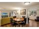 Dining area open to living space, featuring a round table, dark chairs, and modern lighting at 3053 Concord St, Sarasota, FL 34231