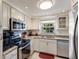 Well-lit kitchen features granite counters, stainless steel appliances, and a view from the large window at 3053 Concord St, Sarasota, FL 34231
