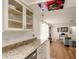 Bright kitchen with granite countertops, white cabinets, and stainless steel dishwasher leading to the living room at 3053 Concord St, Sarasota, FL 34231