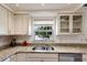 Bright kitchen features granite counters, stainless steel appliances, and a view from the large window at 3053 Concord St, Sarasota, FL 34231