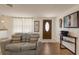 Inviting living room featuring hardwood floors, neutral colors, and a decorative front door at 3053 Concord St, Sarasota, FL 34231