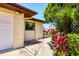 Home exterior with a well-manicured garden, driveway, and attached garage at 3208 Vivienda Blvd, Bradenton, FL 34207