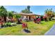 Charming single-story home with a well-manicured lawn and vibrant landscaping at 3208 Vivienda Blvd, Bradenton, FL 34207