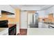 This home's kitchen features stainless steel appliances, white cabinetry and a range at 3208 Vivienda Blvd, Bradenton, FL 34207