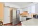 This home's kitchen features stainless steel appliances, white cabinetry and a bar at 3208 Vivienda Blvd, Bradenton, FL 34207