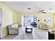 Bright living room with tile floors, ceiling fan, and view into the adjacent room at 3208 Vivienda Blvd, Bradenton, FL 34207