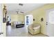 Open-concept living room with tile floors, a ceiling fan, and lots of natural light at 3208 Vivienda Blvd, Bradenton, FL 34207