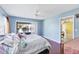 The main bedroom features wood flooring, a sliding glass door and light blue walls at 3208 Vivienda Blvd, Bradenton, FL 34207