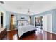 Main bedroom features a ceiling fan, wood floors, and sliding glass doors to the exterior at 3208 Vivienda Blvd, Bradenton, FL 34207