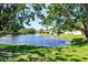 Beautiful lake view with fountain and green grass with buildings in the distance at 3208 Vivienda Blvd, Bradenton, FL 34207