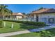Community pool with nearby pool house and lush green lawn at 3208 Vivienda Blvd, Bradenton, FL 34207